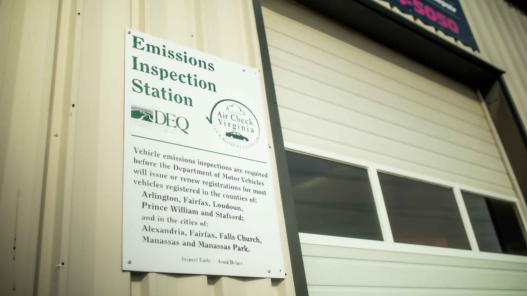 emissions inspections sign on building